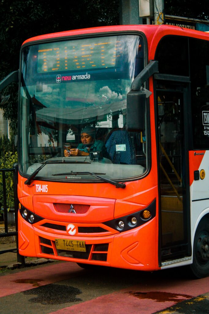 A vibrant city bus on route in Jakarta, showcasing urban life and daily transportation.
